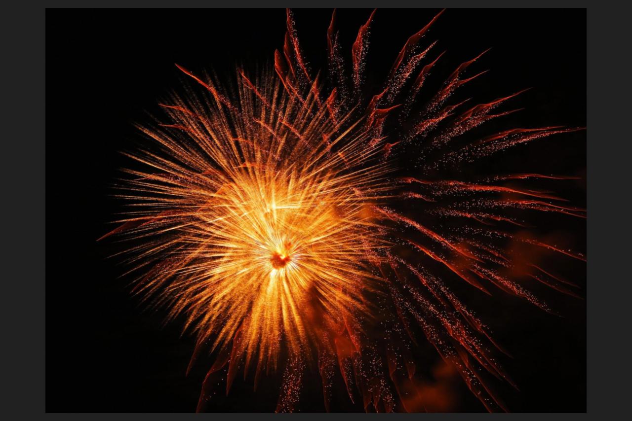 orange firework on black background