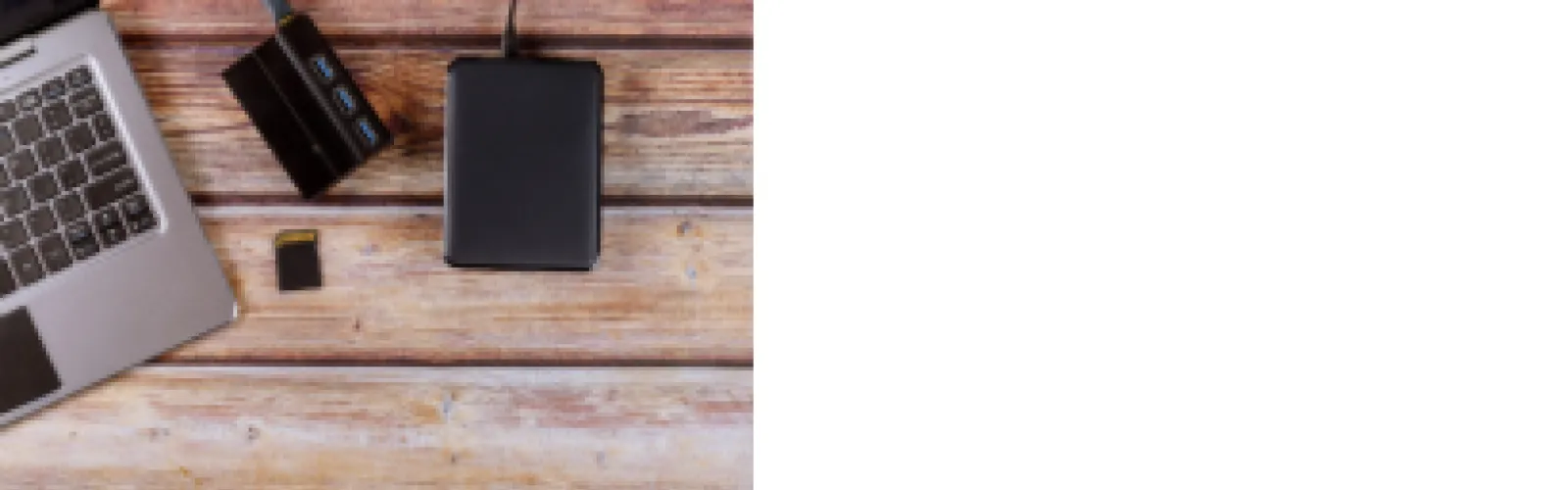 wood desk background with computer and photo storage tools