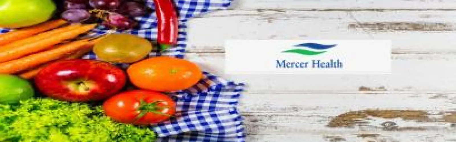 gray background with fruits and vegetables in left hand corner of image. Mercer Health Logo is in the middle of the image with green and blue lettering